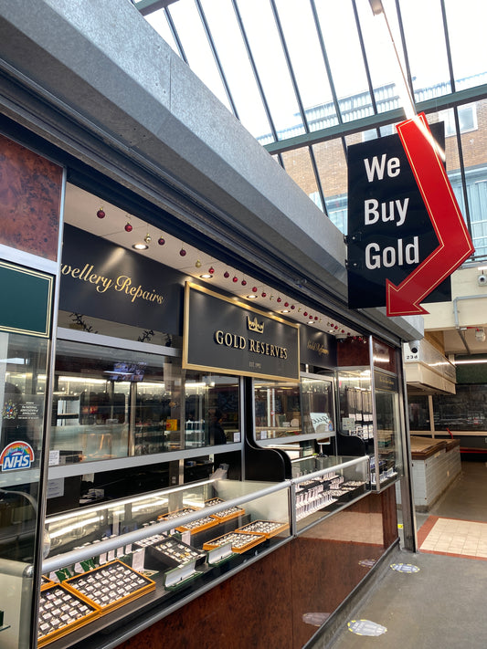 Our Gold Reserves Swansea Market stall with our sign that says 'We Buy Gold' and we have our gold vintage jewellery featured