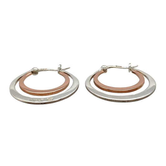 Bring elegant contrast and heritage style to your collection with these pre-owned Clogau double hoop creole earrings in sterling silver and 9ct rose gold, offering timeless design with a modern twist—perfect for both everyday wear and special occasions.
Design: Each earring features an interlocking double hoop creole style, combining flowing curves with a distinctive two-tone look.