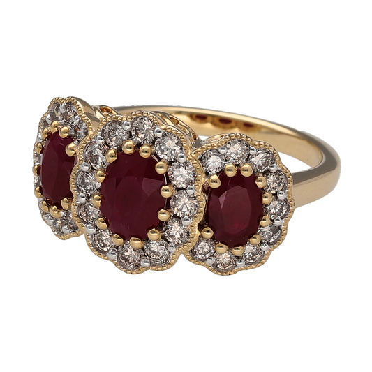 New 9ct Yellow and White Gold Diamond & Ruby Set Trilogy Cluster Ring in size N with the weight 5.30 grams. The front of the ring is 12mm high and the center ruby stone is 7mm by 5mm. There is approximately 0.85ct of diamond content set in total
