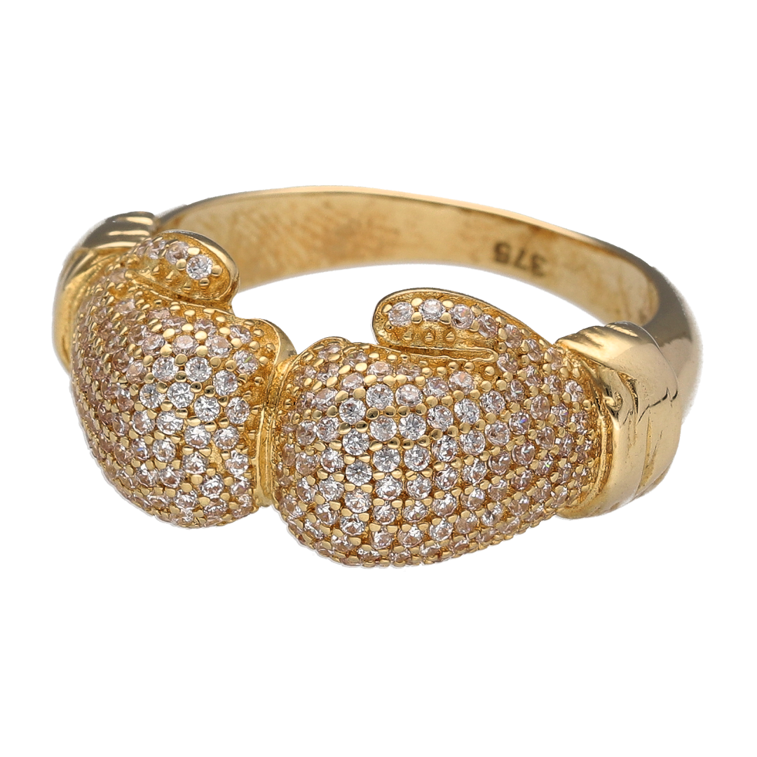 Bring bold impact and champion style to your collection with this new 9ct yellow gold and cubic zirconia set double boxing glove ring—a powerful design that symbolises strength, determination, and pride.
Design: The ring features a striking 12mm high front with two detailed boxing gloves facing each other, accented with sparkling cubic zirconia to highlight the form and add eye-catching brilliance.