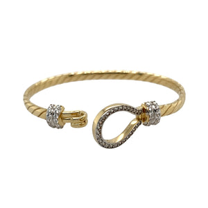 New 9ct Yellow and White Solid Gold & Cubic Zirconia Set Twisted Horseshoe Baby Bangle with the weight 10.50 grams. The front of the bangle is 13mm high and the main bangle band is 4mm. The bangle diameter is 5cm