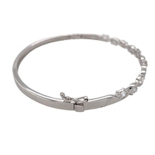 Load image into Gallery viewer, Preowned 9ct White Gold &amp; Cubic Zirconia Set Oval Hinged Bangle with the weight 8.30 grams. The bangle diameter is 6cm and the stones are each approximately 5mm by 2.5mm 
