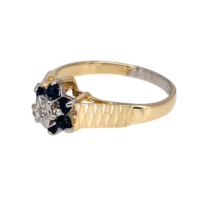 Preowned 9ct Yellow and White Gold Diamond & Sapphire Set Flower Cluster Ring in size K with the weight 1.60 grams. The sapphire stones are each 2mm diameter and the front of the ring is 8mm high