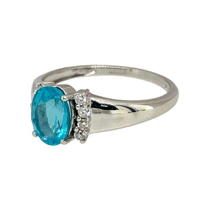 Preowned 9ct White Gold Diamond & Blue Stone Set Ring in size O with the weight 2.60 grams. The blue stone is 8mm by 6mm