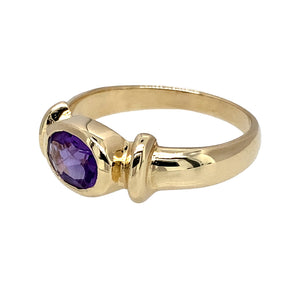 Preowned 9ct Yellow Gold & Amethyst Oval Cut Set Ring in size N with the weight 3.10 grams. The amethyst stone is 7mm by 5mm
