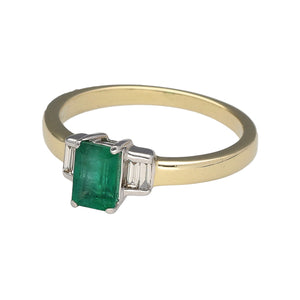 Preowned 9ct Yellow and White Gold Diamond & Emerald Set Ring in size M with the weight 2.30 grams. The emerald is 6mm by 4mm and there is approximately 20pt of diamond content in total