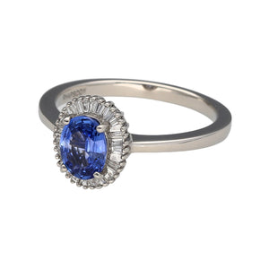 Preowned Platinum Diamond & Sapphire Set Cluster Ring in size T with the weight 7 grams. The sapphire stone is cornflower blue and is 8mm by 6mm surrounded by 29 tapered baguette cut diamonds