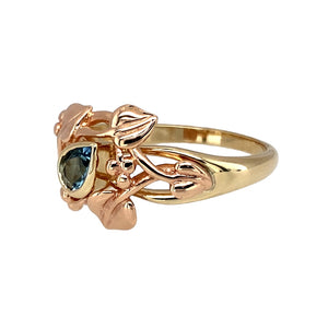 Preowned 9ct Yellow and Rose Gold & Blue Topaz Clogau Tree of Life Ring in size R with the weight 4 grams. The front of the ring is 14mm high and the topaz stone is 6mm by 4mm