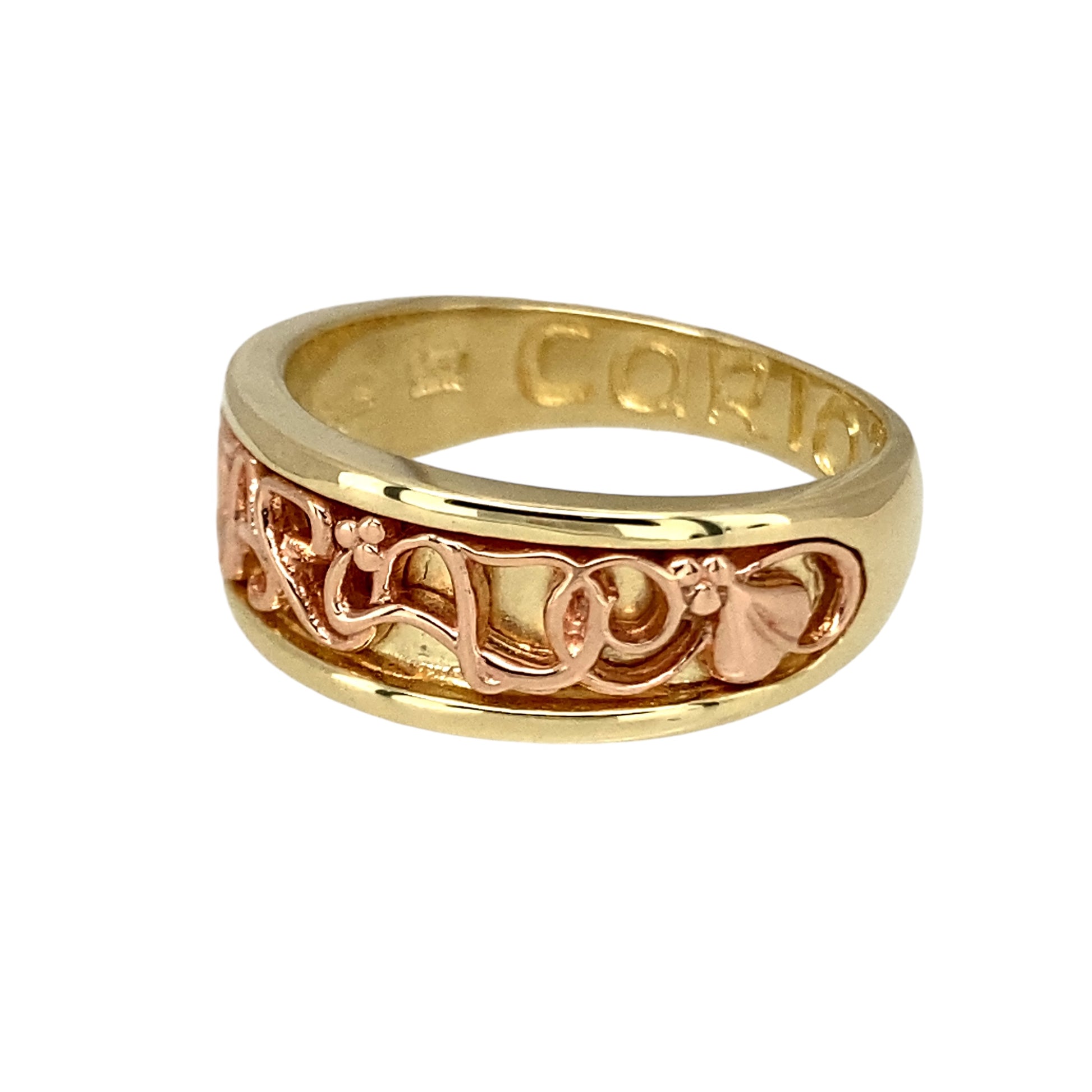 Bring heartfelt meaning and elegant design to your collection with this pre-owned 9ct yellow and rose gold Clogau Cariad band ring, symbolising love and affection—perfect for marking special moments with timeless Welsh heritage.
Design: The front of the band measures 7mm wide and features the word Cariad (Welsh for "beloved") engraved in a flowing script, framed by softly polished edges and subtle rose gold detailing for a warm, meaningful contrast.