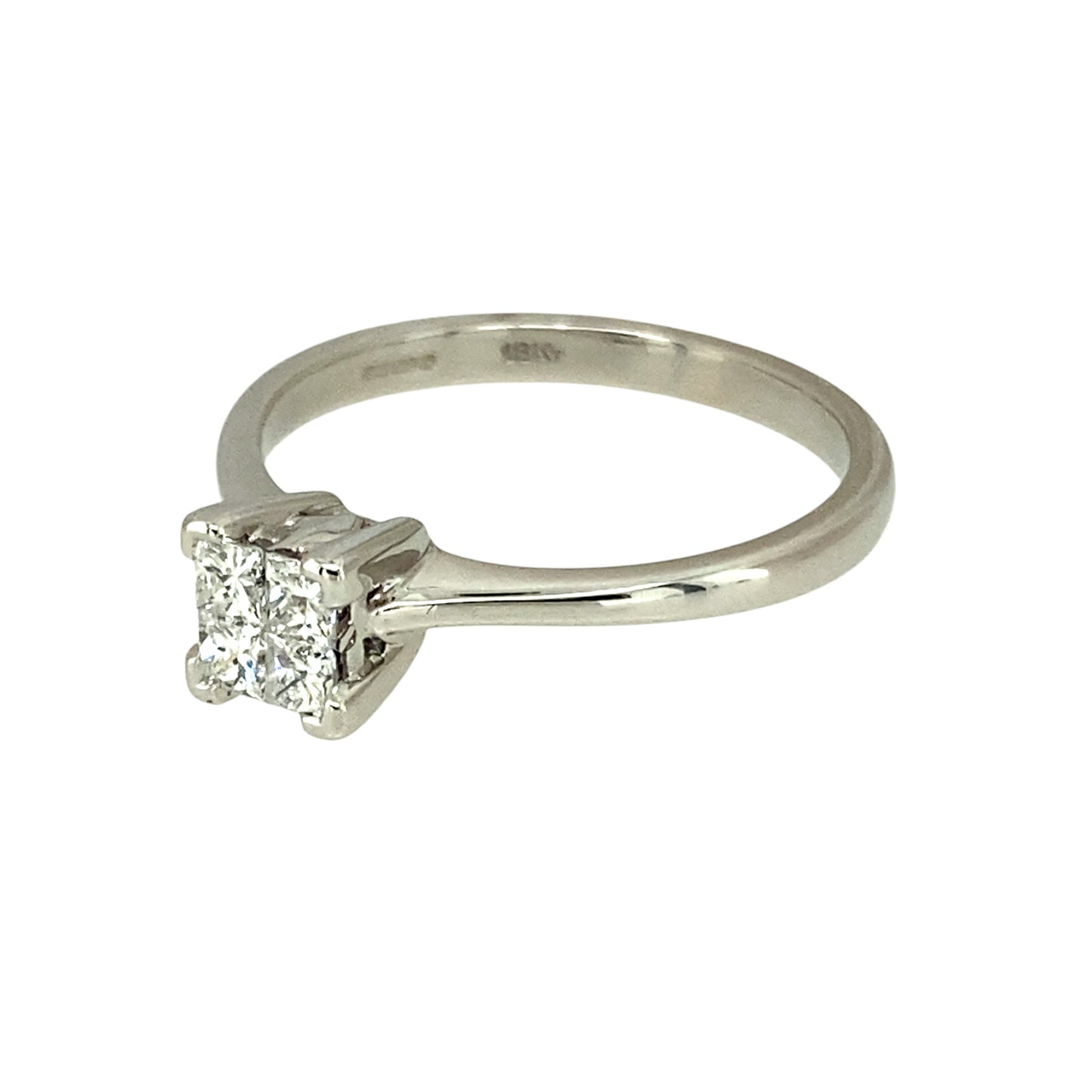 Preowned 9ct White Gold & Diamond Illusion Set Solitaire Ring in size L with the weight 2.50 grams. There are four princess cut diamonds set together to give the impression of one larger stone. There is approximately 0.24ct of diamond content set in total but gives the impression of approximately 0.40ct