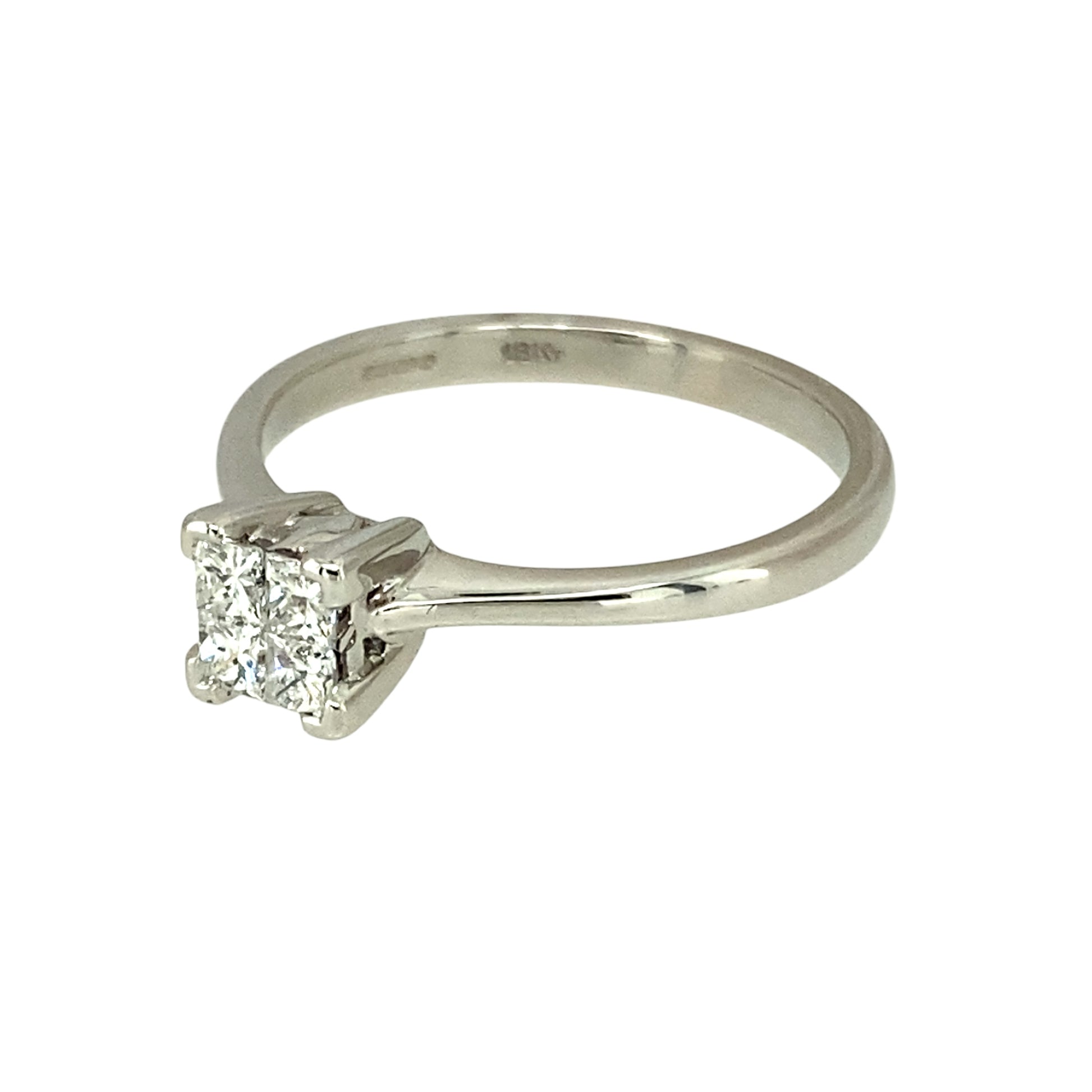 Preowned 9ct White Gold & Diamond Illusion Set Solitaire Ring in size L with the weight 2.50 grams. There are four princess cut diamonds set together to give the impression of one larger stone. There is approximately 0.24ct of diamond content set in total but gives the impression of approximately 0.40ct