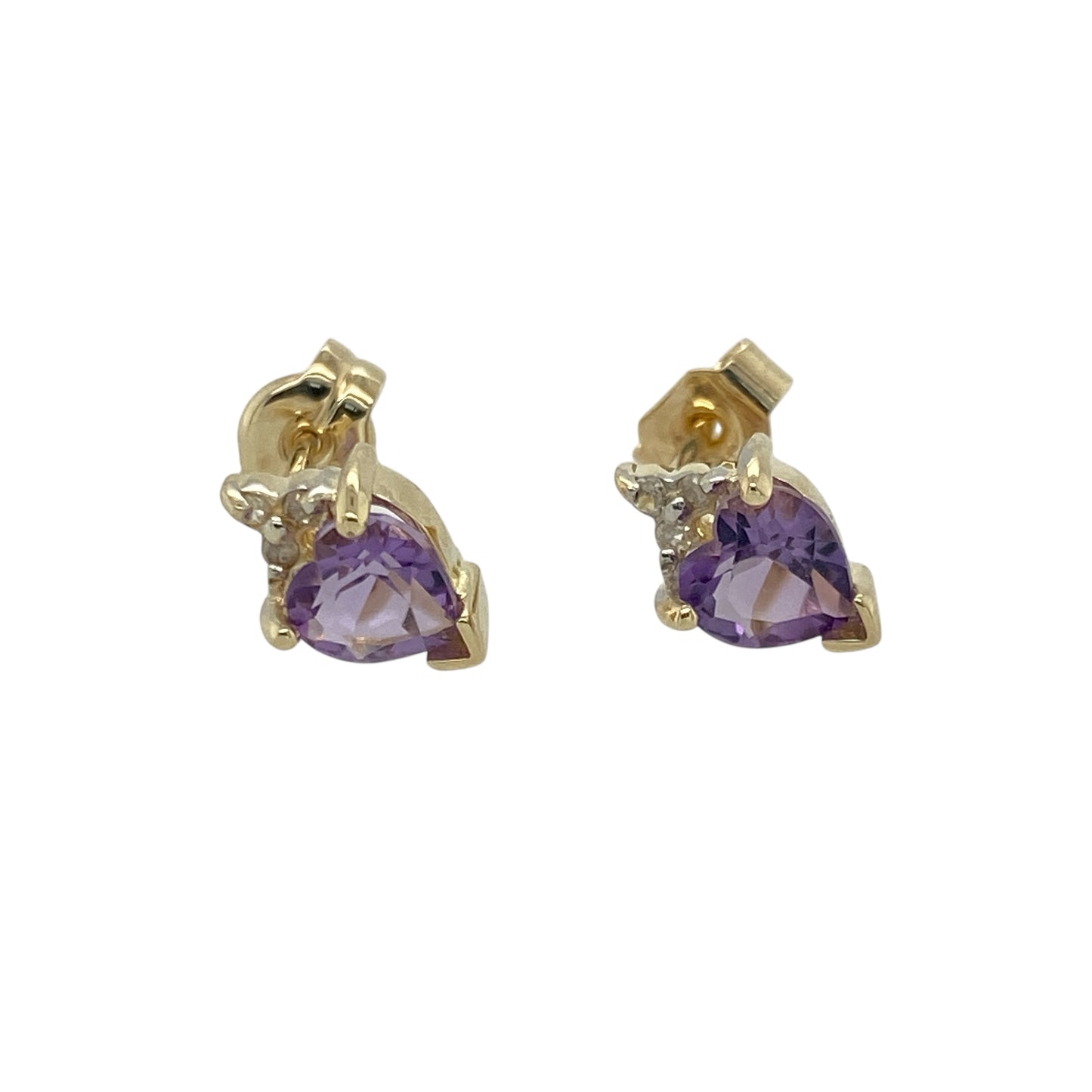 Bring romantic colour and subtle sparkle to your look with these pre-owned 9ct yellow gold diamond and amethyst set heart stud earrings—perfect for adding a touch of feminine elegance to any occasion.
Design: Each earring features a 5mm heart-shaped amethyst, radiating rich purple tones that symbolise love and calm. A delicate diamond accent adds sparkle above each stone, enhancing the romantic design.