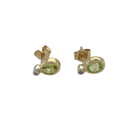 Pre-owned 9ct Yellow Gold Diamond & Peridot Set Stud Earrings with the weight 0.70 grams. The oval peridot stones are each 4mm by 3mm