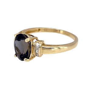 Preowned 9ct Yellow Gold Diamond & Dark Navy Blue/Purple Stone Set Ring in size P with the weight 1.90 grams. The stone is 9mm by 7mm