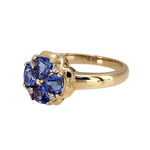 Preowned 9ct Yellow Gold Diamond & Tanzanite Set Flower Ring in size O with the weight 4.10 grams. The front of the ring is 12mm high and the tanzanite stones are each approximately 4.5mm by 4.5mm by 4.5mm