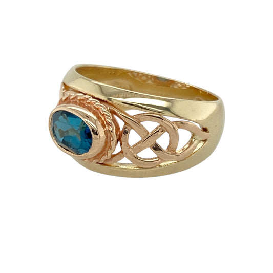 Add heritage detail and vibrant colour to your collection with this pre-owned early Clogau ring in 9ct yellow and rose goldβfeaturing rich symbolism and elegant gemstone beauty.
Design: The ring showcases a 7mm by 5mm blue topaz at the centre, framed by intricate Celtic knot shoulders in yellow and rose gold, symbolising eternity and unity.
Material: Made from 9-carat yellow and rose gold, the polished finish highlights the contrast of metals and the brilliance of the topaz.