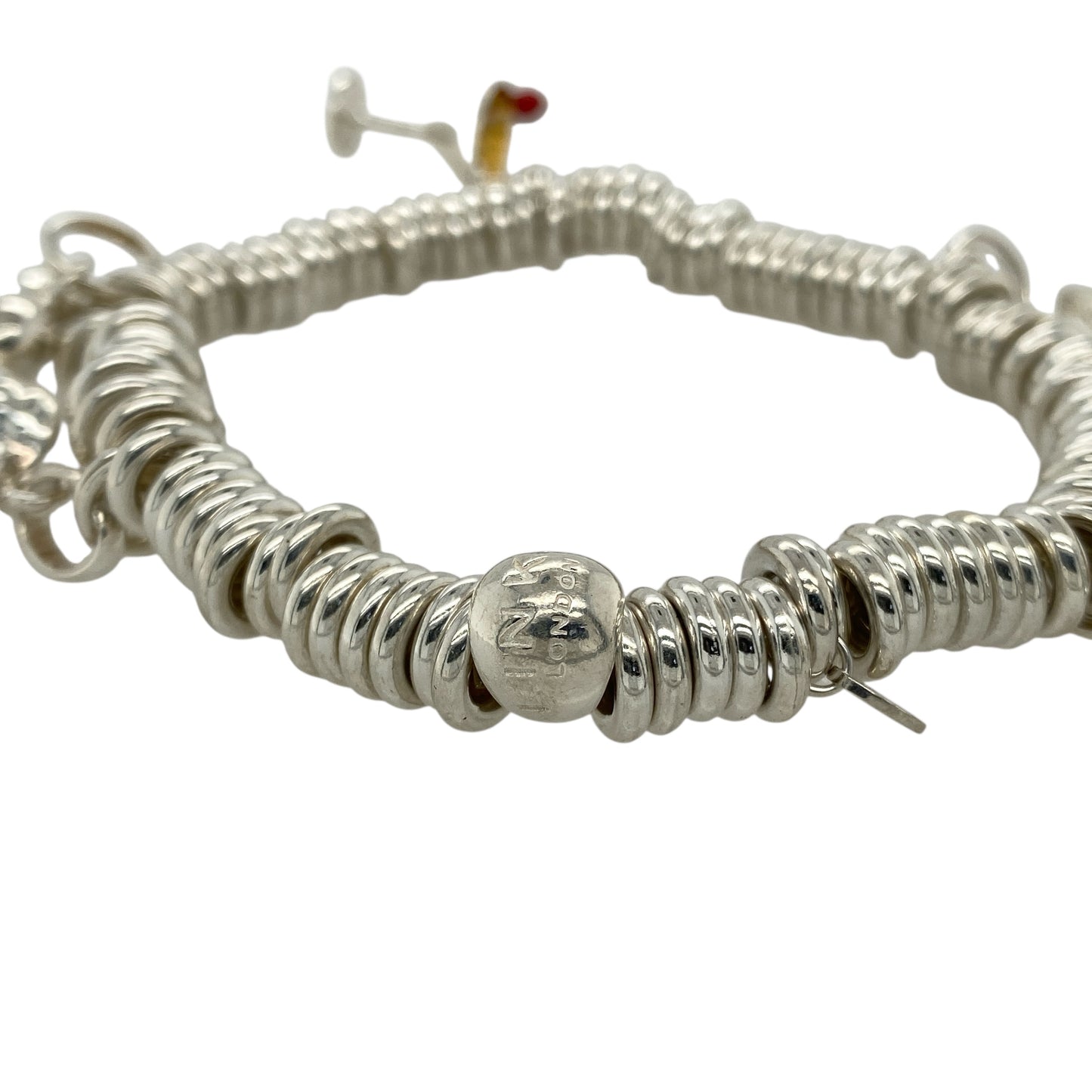 Add playful elegance and personal style to your collection with this pre-owned 925 silver 8" Links of London charm bracelet—a delightful piece that captures joyful spirit and timeless charm, perfect for expressing your personality every day or on special occasions.
Design: This bracelet features a classic Links of London chain adorned with five unique charms: an angel, cocktail glass, heart, elephant, and a frog with a crown, each offering its own symbolic meaning and playful character.