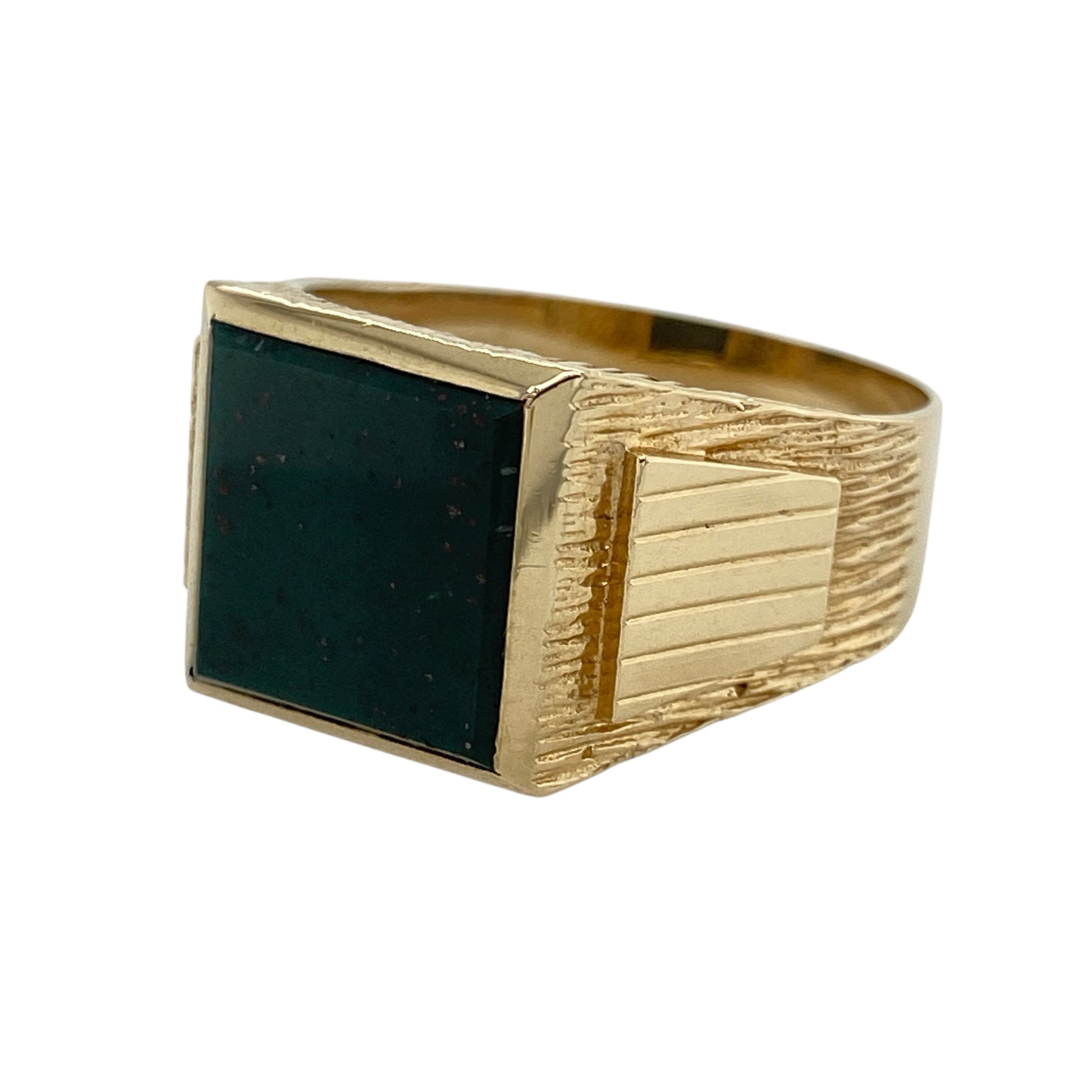 Bring rich colour and bold presence to your collection with this pre-owned 9ct gold bloodstone square signet ring—perfect for making a distinguished statement or adding a touch of heritage style to your look.
Design: The ring features an 11mm by 11mm square bloodstone at the centre, framed by patterned shoulders for added detail and character.
Material: Made from 9-carat gold, the polished finish complements the deep green of the bloodstone and highlights the intricate shoulder design.