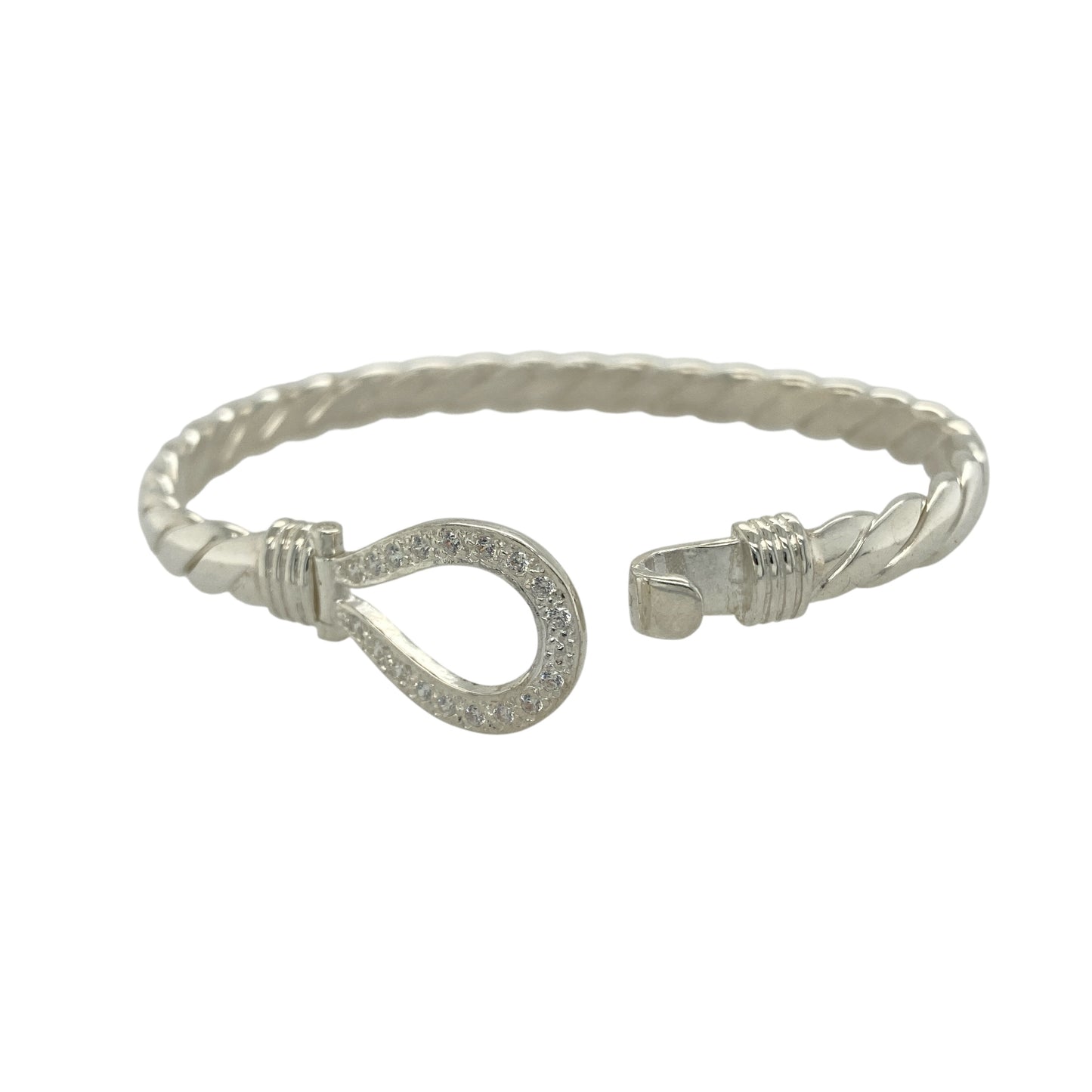 Bring timeless elegance and refined sparkle to your collection with this new 925 silver cubic zirconia horseshoe bangle, a beautifully crafted piece symbolising luck and protection.
Design: The bangle features a 15mm high front with a classic horseshoe motif, accented with sparkling cubic zirconia stones and set on a solid twisted silver band for a striking, elegant finish.