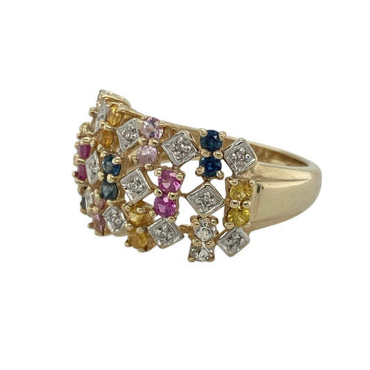 Add vibrant colour and contemporary elegance to your collection with this pre-owned 9ct yellow gold diamond and multicoloured sapphire set wide band ring — a striking piece that beautifully combines modern design with timeless luxury.
Design: The openwork band features an array of yellow, pink, and blue sapphires accented with sparkling diamonds, creating a lively display of colour and light across the 12mm wide band. The open design adds depth and dimension for a bold yet refined look.