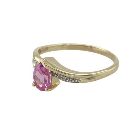 Add a touch of vibrant elegance to your collection with this pre-owned 9ct yellow gold diamond and pink sapphire set twist ring — a graceful design that combines feminine colour with timeless sparkle.
Design: The ring features a 7mm by 5mm teardrop-shaped pink sapphire at the centre, beautifully complemented by a delicate twist design adorned with sparkling diamonds along the shoulders for added brilliance and flow.