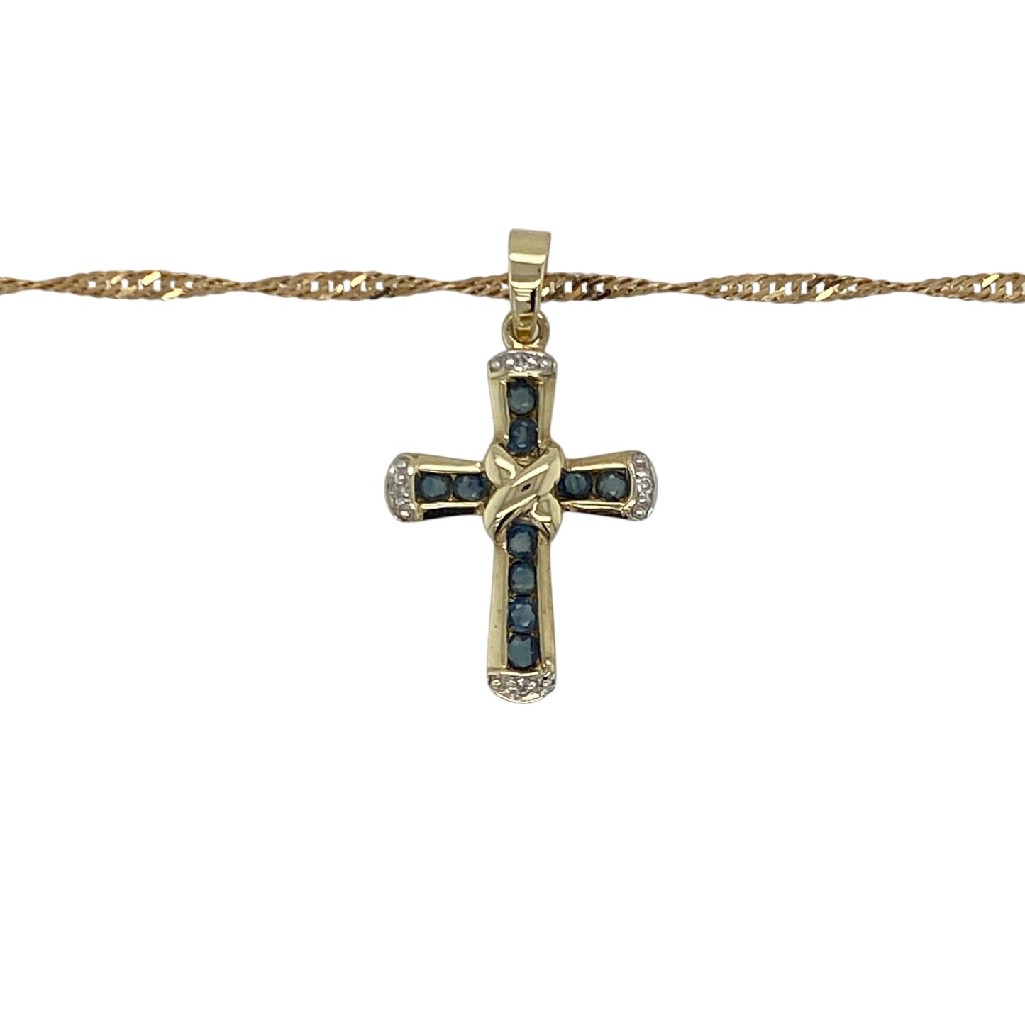 Add timeless beauty and classic sparkle to your collection with this pre-owned 9ct yellow gold diamond and sapphire set cross pendant on an 18" Singapore chain necklace — a refined piece that blends faith and elegance.
Design: The pendant features a delicate cross adorned with rich blue sapphires and sparkling diamonds, creating a graceful balance of colour and brilliance. Measuring 2.5cm long including the bail, it offers a subtle yet eye-catching presence.