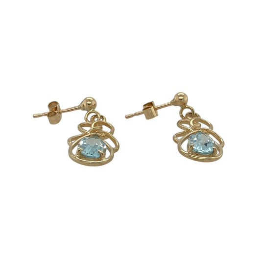 Add a touch of graceful colour and flowing elegance to your collection with these pre-owned 9ct yellow gold oval blue stone twist drop earrings — a refined design that captures light and movement beautifully.
Design: Each earring features an aqua-coloured oval stone measuring 7mm by 5mm, set within an elegant twisted gold drop that enhances the stone’s sparkle and fluid form.