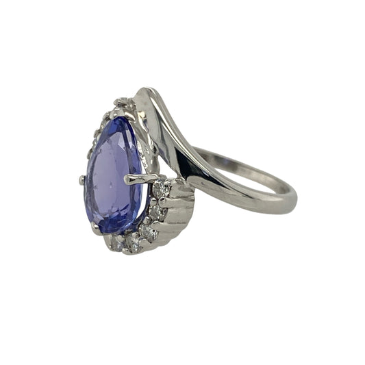 Pre-owned 18ct White Gold Diamond & Tanzanite Set Teardrop Twist Ring in size L with the weight 3.60 grams. The teardrop tanzanite stone is 10mm by 7mm