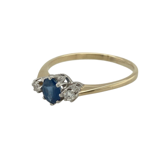 Pre-owned 9ct Yellow Gold Diamond & Sapphire Set Trilogy Ring in size O with the weight 1.60 grams. The center sapphire is 5mm by 4mm and there is a diamond on each side