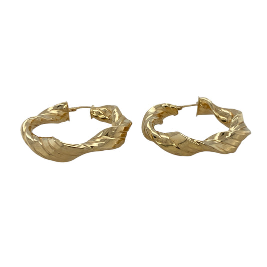 Bring bold texture and elegant movement to your collection with these pre-owned 9ct yellow gold ribbon twisted creole earrings—an eye-catching pair offering refined shine and timeless appeal.
Design: These hoop creole earrings feature a ribbon-style twisted design, creating flowing curves and layered depth that catch the light beautifully.
Material: Made from 9-carat yellow gold, the earrings display a polished, radiant finish that enhances their sculpted detailing.