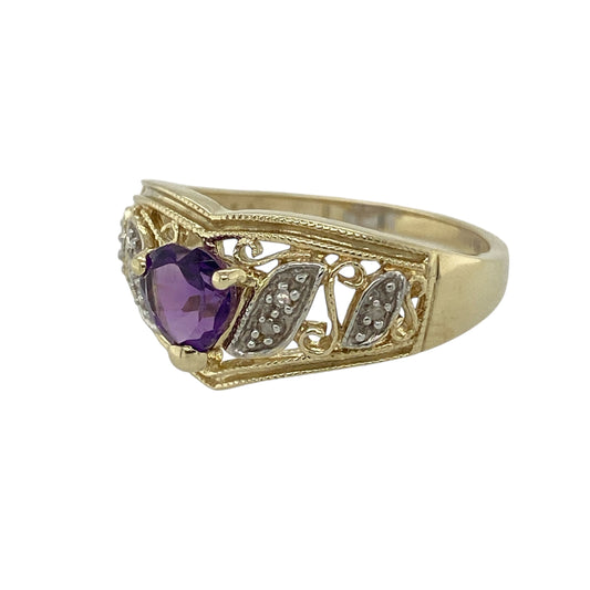 Bring vibrant colour and graceful symbolism to your collection with this pre-owned 9ct yellow and white gold diamond and amethyst wishbone ring—an elegant piece that blends sentiment, sparkle, and timeless style.
Design: This beautiful wishbone-style ring features a 6mm heart-shaped amethyst at the centre, offering a romantic focal point with rich purple colour. Diamond accents along the white gold curve add gentle sparkle, while the yellow gold band enhances the flowing, meaningful shape.