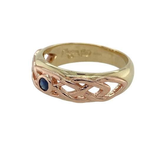 Bring rich colour and traditional symbolism to your collection with this pre-owned 9ct yellow and rose gold sapphire Celtic band ringβan elegant piece that blends heritage design with timeless gemstone charm.
Design: The front of the band measures 7mm wide and features an intricate Celtic knot pattern centred around a 3mm sapphire, adding subtle sparkle and vibrant blue colour. The detailed knotwork creates a meaningful, expressive look with classic appeal.