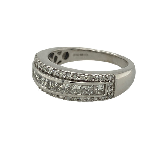 Bring bold luxury and exceptional sparkle to your jewellery collection with this pre-owned 18ct white gold & diamond set band ring, offering an eye-catching design with impressive presence.
Design: The ring features a wide band with a striking diamond arrangement, showcasing a central panel of princess-cut diamonds framed by brilliant-cut diamonds for maximum impact.