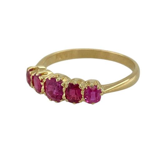 Bring rich colour and classic elegance to your jewellery collection with this pre-owned 18ct yellow gold ruby five stone band ring, a refined design featuring graduated gemstones and timeless appeal—ideal for special occasions or everyday luxury.
Design: The ring showcases five graduating rubies arranged across the front of the band, with a rounded square centre ruby measuring approximately 4mm by 4mm. The graduating layout creates a balanced and elegant profile with beautiful visual flow.