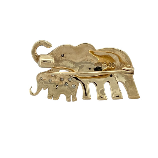 Bring charming symbolism and delicate sparkle to your jewellery collection with this pre-owned 9ct yellow and white gold diamond set elephant brooch, a beautifully detailed piece celebrating family and connection.
Design: The brooch depicts two elephants—a mother and baby—captured in a tender and decorative composition. The smaller elephant is fully accented with diamonds, while the larger elephant features a single diamond set as the eye, adding subtle brilliance and character.