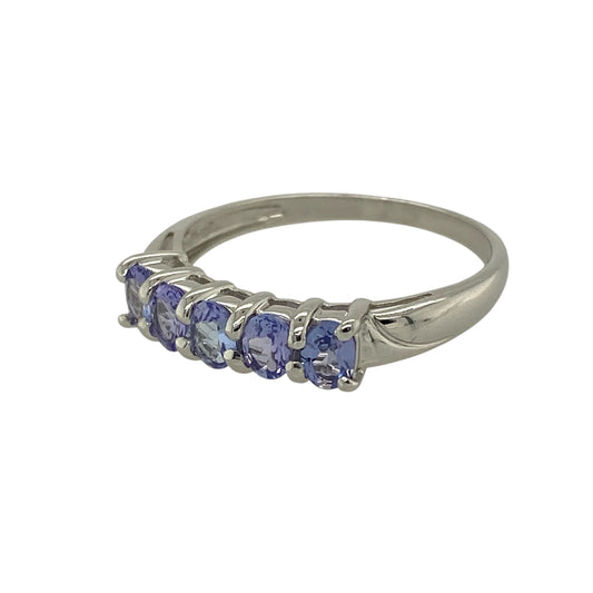 Bring rich colour and refined elegance to your jewellery collection with this pre-owned 9ct white gold tanzanite set five stone band ring, offering a timeless design with beautiful balance—perfect for everyday wear or special occasions.
Design: The ring features five oval tanzanite stones, each measuring approximately 4mm by 3mm, arranged in a classic row to create a striking and harmonious look.