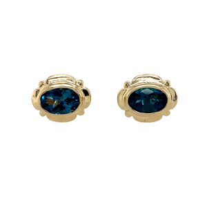 Preowned 9ct Yellow Gold & Blue Topaz Oval Stud Earrings with the weight 1.70 grams. The blue topaz stones are each 7mm by 5mm