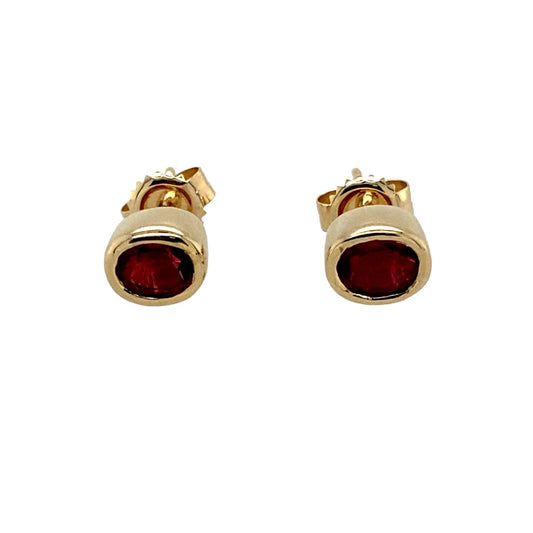 Preowned 9ct Yellow Gold & Red Stone Oval Stud Earrings with the weight 1.50 grams. The red stones are each approximately 4.5mm by 3.5mm