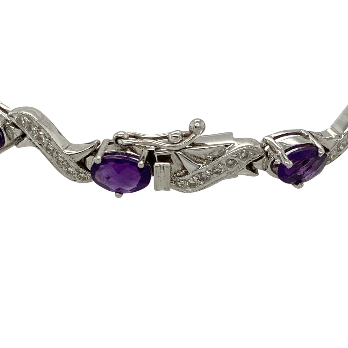 Bring vibrant colour and refined sparkle to your collection with this pre-owned 18ct white gold diamond and amethyst bracelet—perfect for adding elegance to both everyday wear and special occasions.
Design: The 7.25" bracelet features 13 oval amethyst stones, each measuring 6mm by 4mm, interspersed with diamonds for a balanced and eye-catching look.
Material: Made from 18-carat white gold, the polished finish enhances the brilliance of the diamonds and the rich purple hue of the amethysts.