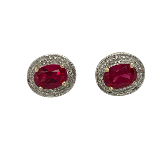 Add rich colour and timeless sparkle to your collection with these pre-owned 9ct yellow and white gold diamond and ruby set halo stud earrings — an elegant pairing of classic gemstones and refined design.
Design: Each earring features an oval-cut ruby measuring 7mm by 5mm, surrounded by a halo of shimmering diamonds that enhance the deep red hue of the centre stones and add beautiful brilliance.