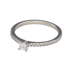 Preowned Platinum & Diamond Set Solitaire Ring with diamond set shoulders. The ring is in size O with the weight 3.40 grams. The center diamond is princess cut and it approximately 18pt with approximate clarity VS2 and colour J - K