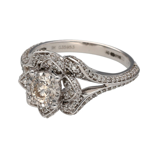 New 9ct White Gold & Diamond Set Flower Ring in size M with the weight 4.30 grams. The front of the ring is 13mm high and the ring contains approximately 1.15ct of diamond content in total. The diamonds are approximate clarity Si
