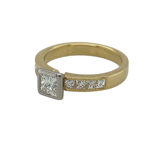 Bring striking sparkle and classic elegance to your jewellery collection with this pre-owned 18ct yellow gold and diamond set princess cut solitaire ring, offering a bold centre stone enhanced by diamond-set shoulders—perfect for special occasions or an engagement ring.
Design: The ring features a central princess-cut diamond with an approximate weight of 0.44ct, complemented by smaller diamonds set along the band, creating a beautifully balanced and eye-catching look.