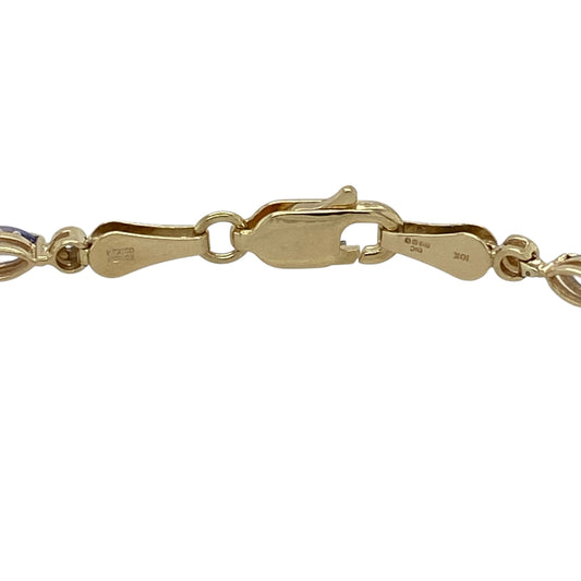 Add elegant colour and refined sparkle to your jewellery collection with this pre-owned 9ct yellow gold diamond and tanzanite set bracelet, offering a graceful design with timeless appealβperfect for everyday wear or special occasions.
Design: The bracelet features marquise-cut tanzanite stones, each measuring approximately 5mm by 2mm, accented with diamond detailing for added brilliance along the length of the bracelet.