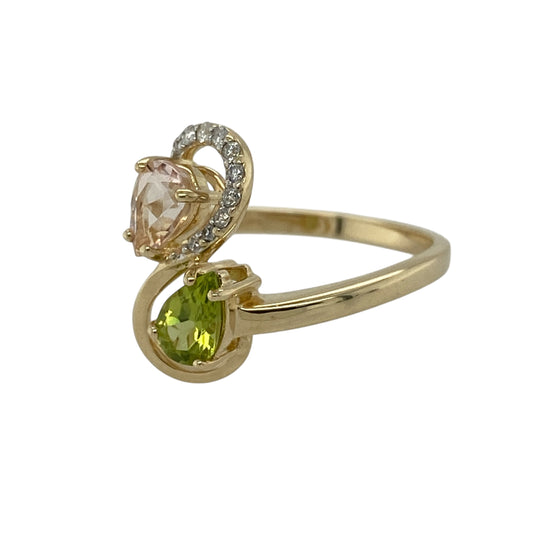 Add vibrant colour and elegant movement to your jewellery collection with this pre-owned 9ct yellow gold diamond and pink and green stone set twist ring, offering a striking design with refined sparkle—perfect for statement wear or special occasions.
Design: The ring features a flowing twist-style design forming an eye-catching front measuring approximately 1.6cm in height, set with teardrop-shaped pink and green stones, each measuring approximately 6mm by 4mm.