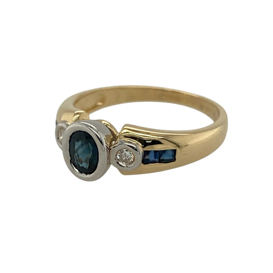 Add refined colour and elegant contrast to your jewellery collection with this pre-owned 18ct yellow and white gold diamond and sapphire set ring, offering classic styling with a touch of modern detail—perfect for special occasions or everyday elegance.
Design: The ring features a central oval sapphire measuring approximately 5mm by 4mm, flanked by two princess-cut diamonds set on the shoulders, creating a beautifully balanced and sophisticated look.