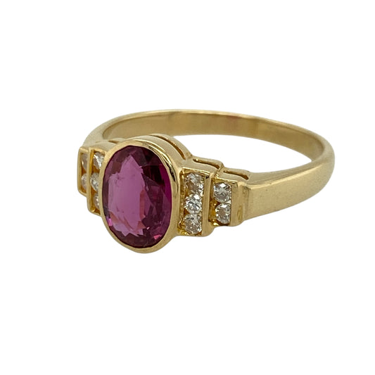 Add rich colour and refined sparkle to your jewellery collection with this pre-owned 18ct yellow gold diamond and ruby ring, offering bold elegance with timeless appeal.
Design: This ring features a striking oval ruby measuring approximately 8mm by 6mm, creating a vibrant and eye-catching centrepiece. Two rows of diamonds on either side enhance the design, adding depth and brilliant contrast.