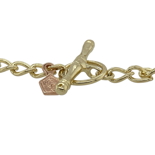Celebrate Welsh heritage with this pre-owned 9ct yellow and rose gold 7" Welsh Gold Clogau charm bracelet, beautifully detailed with symbolic charms in Clogau and Cymru metal. A meaningful and collectible piece perfect for everyday wear or special occasions.
Design: The bracelet features a classic 7-inch link design adorned with an array of intricately detailed charms.
