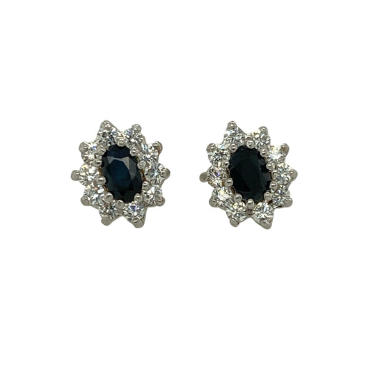 Add vibrant colour and delicate sparkle to your jewellery collection with these pre-owned 9ct yellow gold sapphire and cubic zirconia set cluster stud earrings. A timeless pair perfect for everyday elegance or special occasions.
Design: Each earring features an oval-cut sapphire measuring approximately 5mm by 3mm, forming the centre of a classic cluster design. Surrounding cubic zirconia stones enhance the overall brilliance, creating a beautifully balanced and eye-catching finish.
