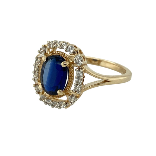 Add striking colour and brilliant sparkle to your jewellery collection with this pre-owned 9ct yellow gold blue stone and cubic zirconia halo ring, designed to offer eye-catching glamour at an accessible priceβperfect as a dress ring or statement piece.
Design: The ring features an 8mm by 6mm oval sapphire-coloured blue stone at the centre, surrounded by a halo of sparkling cubic zirconia.
